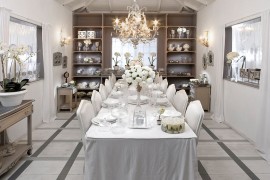 An all-white dining room captures the festive winter magic