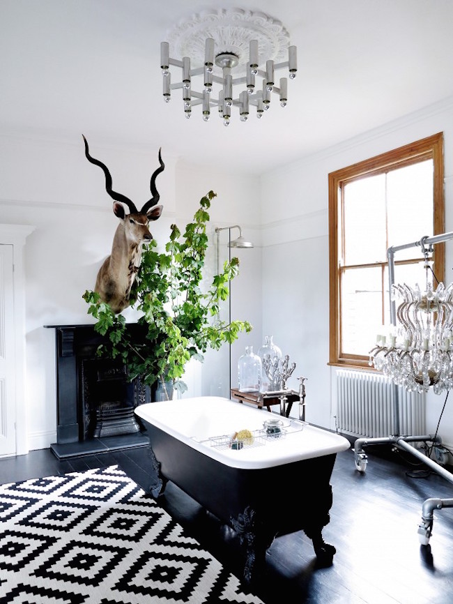 An eclectic bathroom with a gorgeous black clawfoot tub