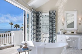 Beach style bathroom flows into the private balcony on one side and master bedroom on the other