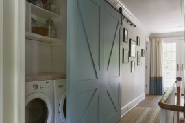 Beautiful blue barn door that hides a washer and dryer