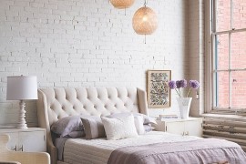 Bedding, lighting, rug and subtle details give this bedroom an air of femininity