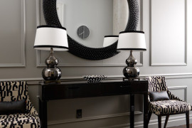 Black and white entryway with large round mirror