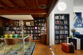 Bookshelves act as a common design element in the living room and dining room