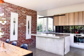 Brick wall backdrop in the kitchen connected with the backyrad