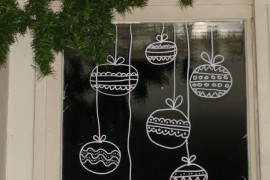 Christmas ornaments draw on window with temporary white marker