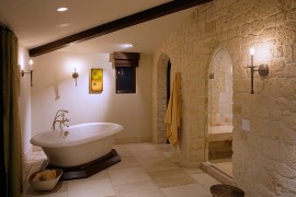Color and texture of the stone give the bathroom a Mediterranean vibe