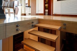 Contemporary wooden staircase leading to the lower private level of the Montreal home