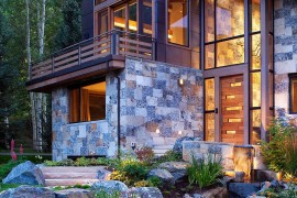 Copper roof and natural dry-stack stone give the mountain home a unique presence