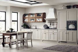 Curved wall units in the corner steal the spotlight in this kitchen