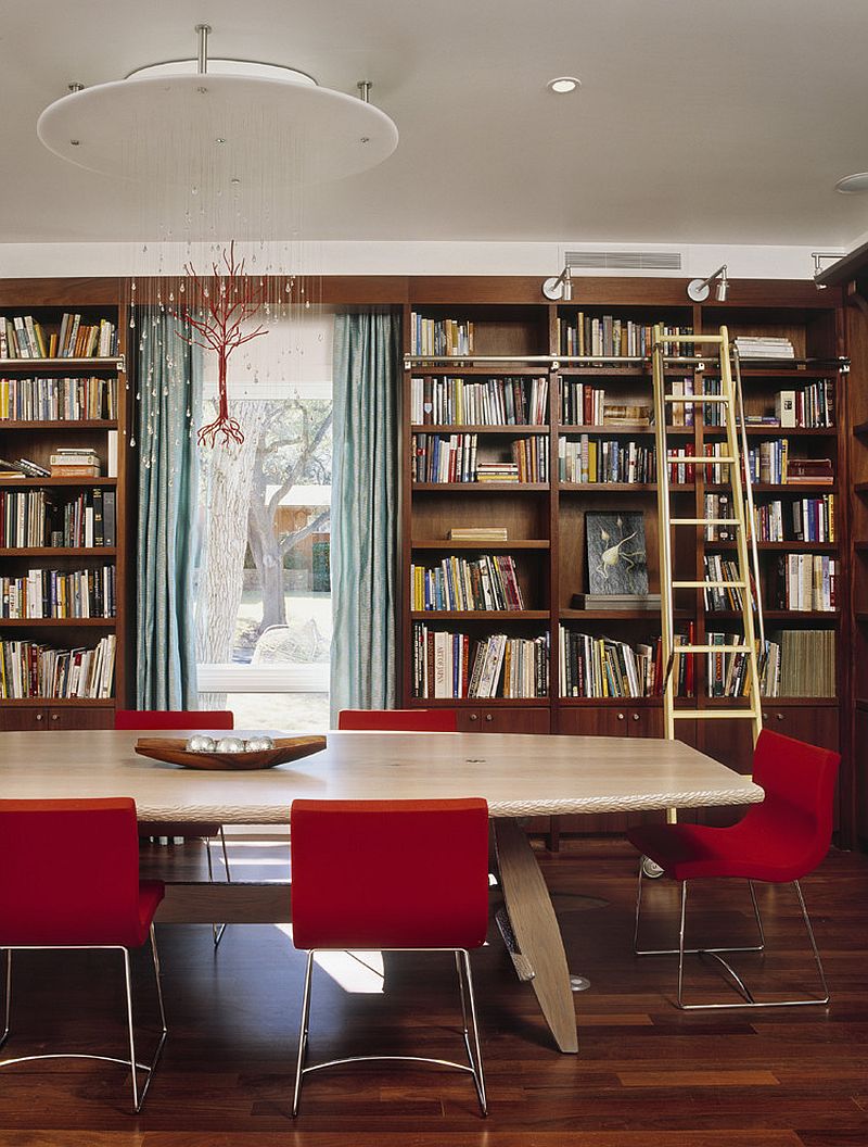 Custom chandelier and fabulous red chairs add color to the home library dining room