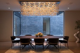 Custom-crafted cascading chandelier steals the show in this LA dining room