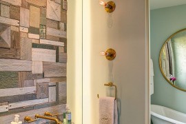 Custom crafted reclaimed wood wall doubles as an artistic addition in the contemporary bathroom