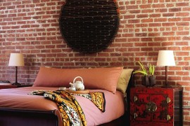 Custom rug and weathered bedside chest usher in an industrial chic style [Design: Amy Lau Design]