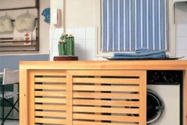 Custom wood box with sliding doors to conceal washer and dryer
