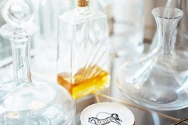 Decanters on a gold-toned bar cart