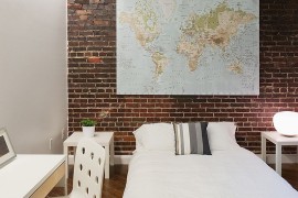 Decorating with a map is an easy way to add color and character to the bedroom [Design: Tiffany Farha Design]