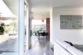 Dining room with metallic pendant and dark dining table chairs