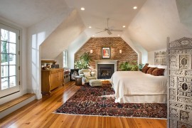 Eclectic and spacious bedroom with burnished plaster and exposed brick walls [Design: McNally Interiors]