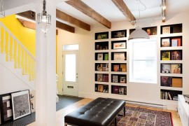 Exposed wooden beams, bookshelves and art work give the interior a distinct character