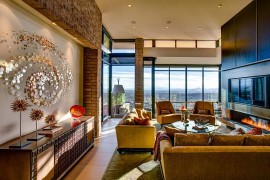 Fabulous living room offers a great view of the city and the distant mountain ranges