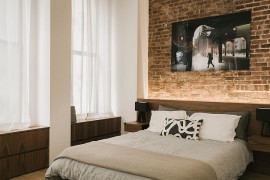 Fabulous use of LED lighting to highlight the accent brick wall in the bedroom [Design: Raad Studio]