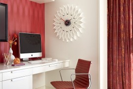 Fusion in Rose wallpaper, chair and the curtain in the backdrop add red to the home office