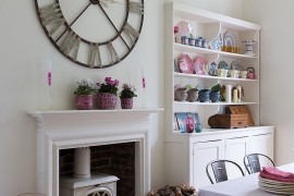 Giant wall clock and corner hutch add personality to this dining room