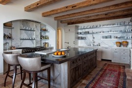 Gorgeous Mediterranean kitchen with antique reclaimed terra cotta flooring and marble counters