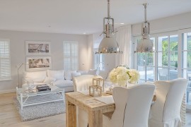 Industrial pendant lights add metallic glint to the chic dining space [From: TRESIQUE]