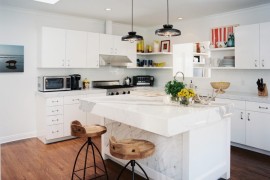 Industrial-style lighting in a kitchen with marble details