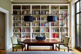 Ladder, bookshelves and bold pendants for the modern library