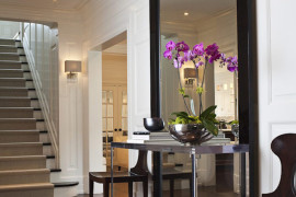 Large full-length mirror with table and chairs in entryway