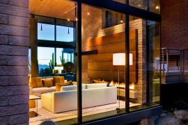 Large glass wall blurs the line between interior and landscape outside
