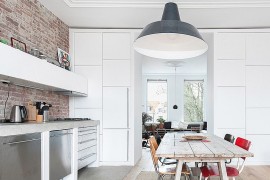 Large industrial style pendant in gray adds personality to the small dining room kitchen combo