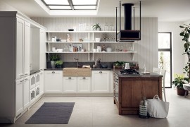 Natural beauty of the woodsy kitchen island stands in contrast with the refined backdrop