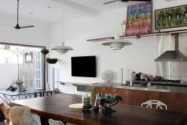 Picture ledge, wall art and carefully-chosen accessories add color to the neutral kitchen and living space