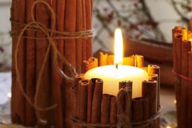 Pillar candles wrapped in cinnamon sticks