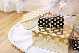 Polka dot gift wrapping paper in gold, black, and white