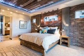 Reclaimed wood ceiling and exposed brick walls in the bedroom