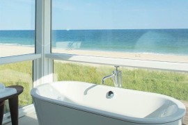 Revamped beach-front home with a bathroom that opens towards the view outside