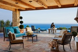 Shaded Mediterranean patio with pool area and ocean views