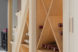 Simple wine storage idea for the small space under the modern staircase