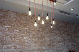 Simplicity of the lighting makes a bold statement in the industrial dining room