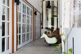 Sliding and folding doors replace walls to create a more cheerful ambiance indoors