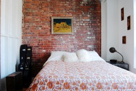 Small industrial bedroom with exposed brick wall