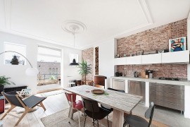 Small kitchen and dining area with exposed brick walls