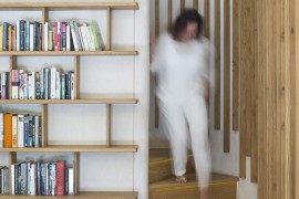 Spiral wooden staircase connects the revamped living area with the top level