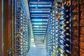 Stunning wine cellar under the staircase with limestone floor