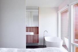 Top level bedroom and bathroom draped in white