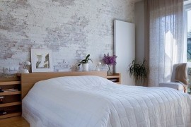 Transitional bedroom lets the brick wall shine through [Design: Nasciturus Design]